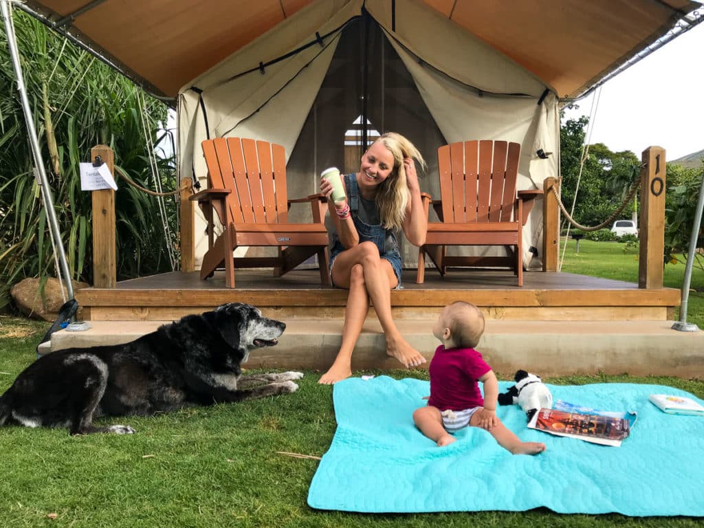 Mom, baby, and dog in front of Camp Olowalu's tentalows in Maui, Hawaii.
