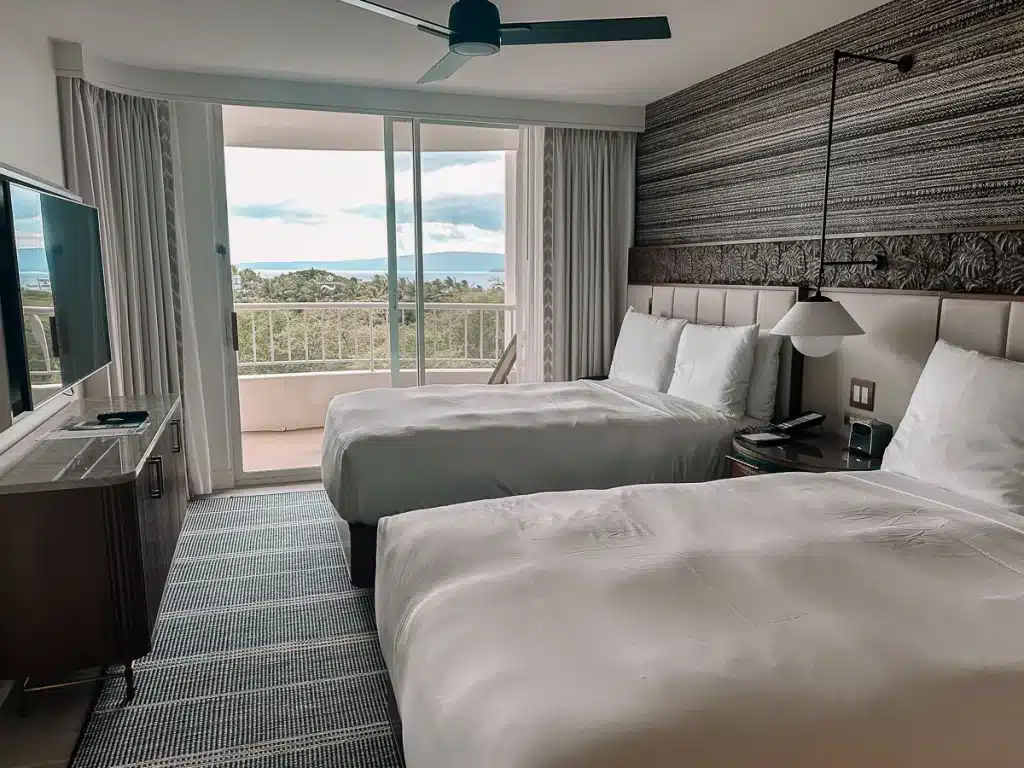 Two beds with an ocean view at Fairmont Kea Lani in Maui, Hawaii.