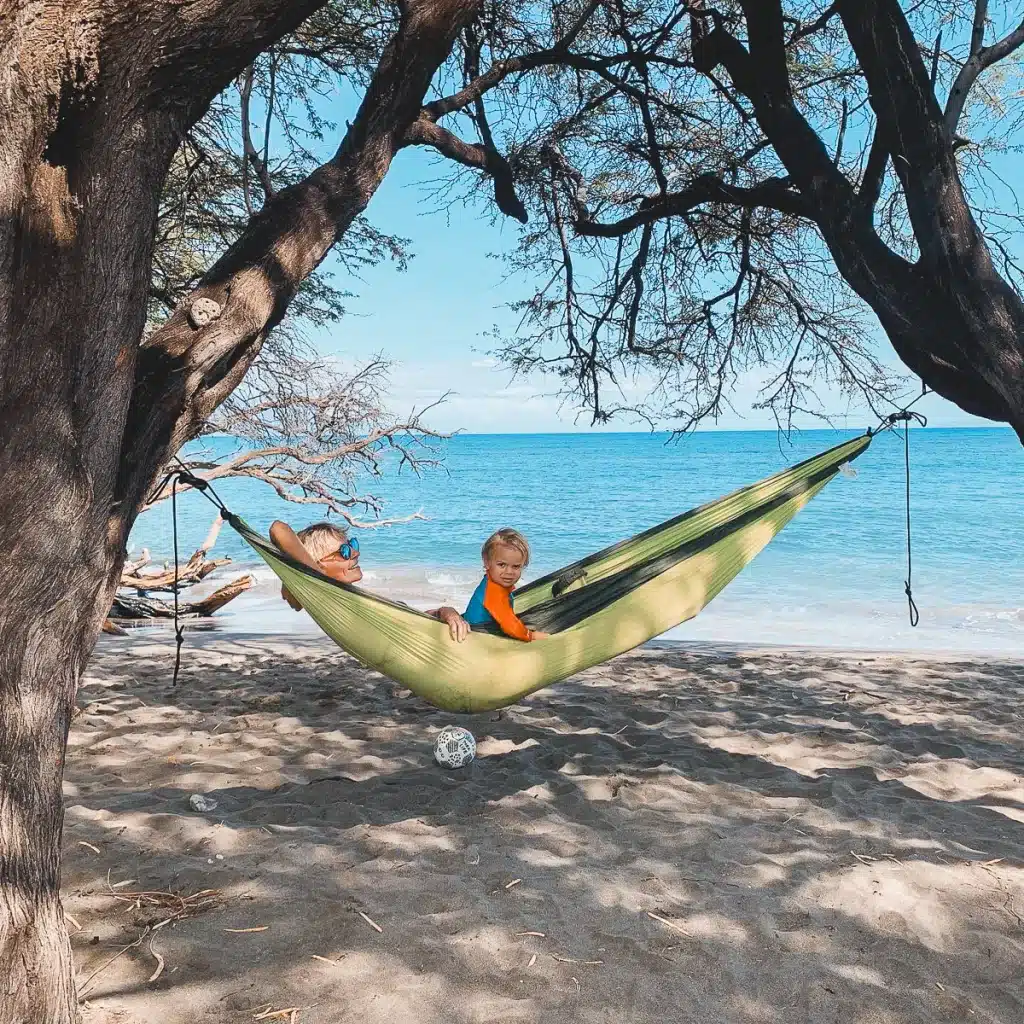 A mom and toddler laying in a hammock on Maui, Hawaii. 