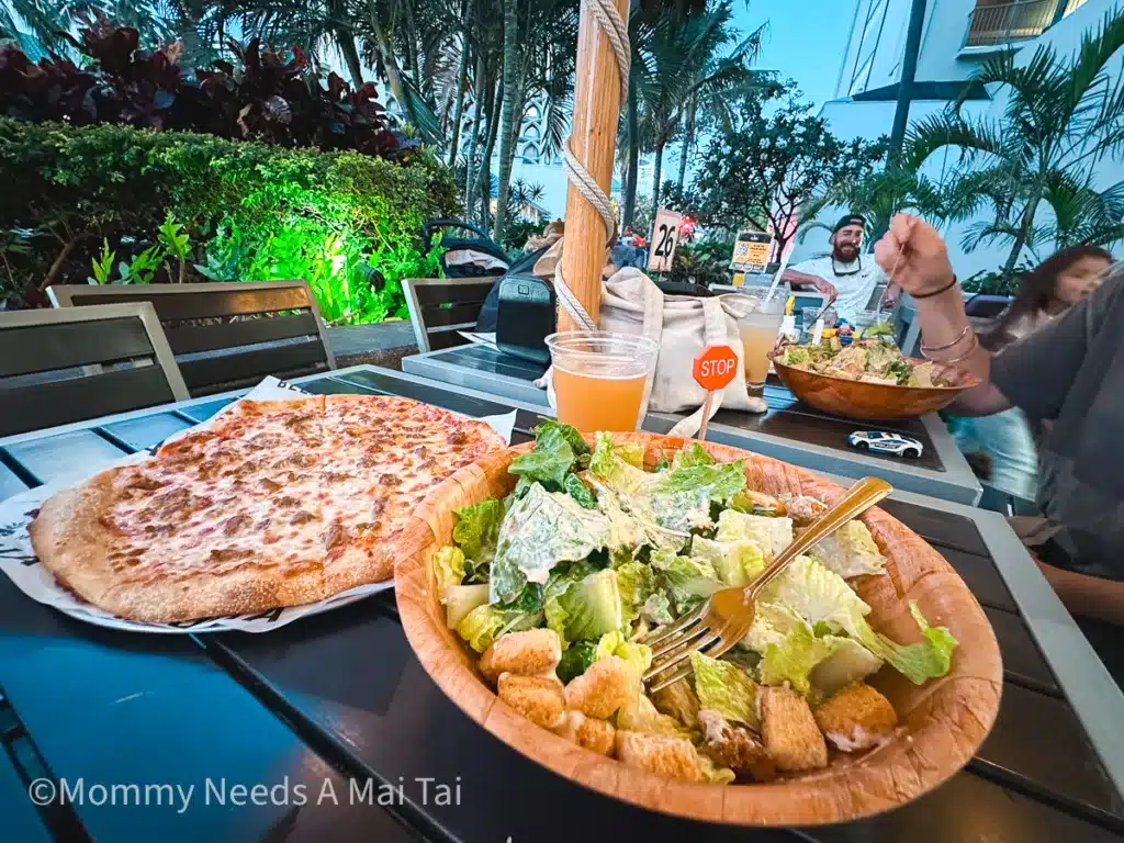Pizza, salad, and beer on the outdoor patio at Aloha Beer Company in Waikiki, Oahu. 