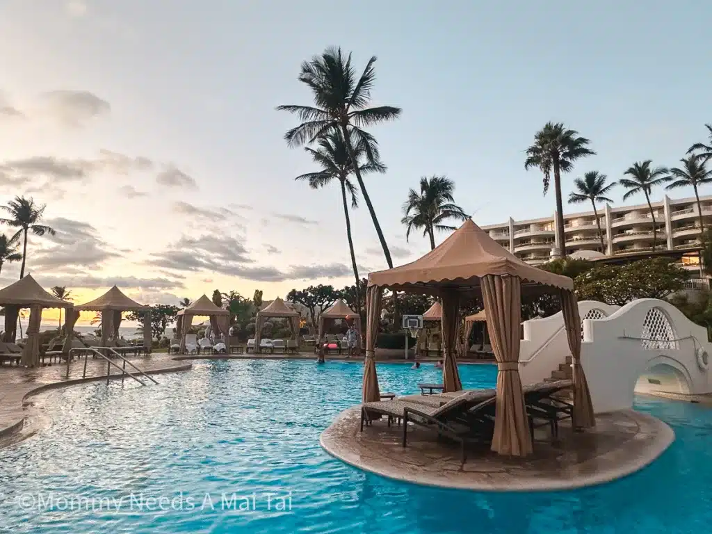 A cabana in the middle of a pool at the Fairmont Kea Lani in Maui, Hawaii as the sun sets. 
