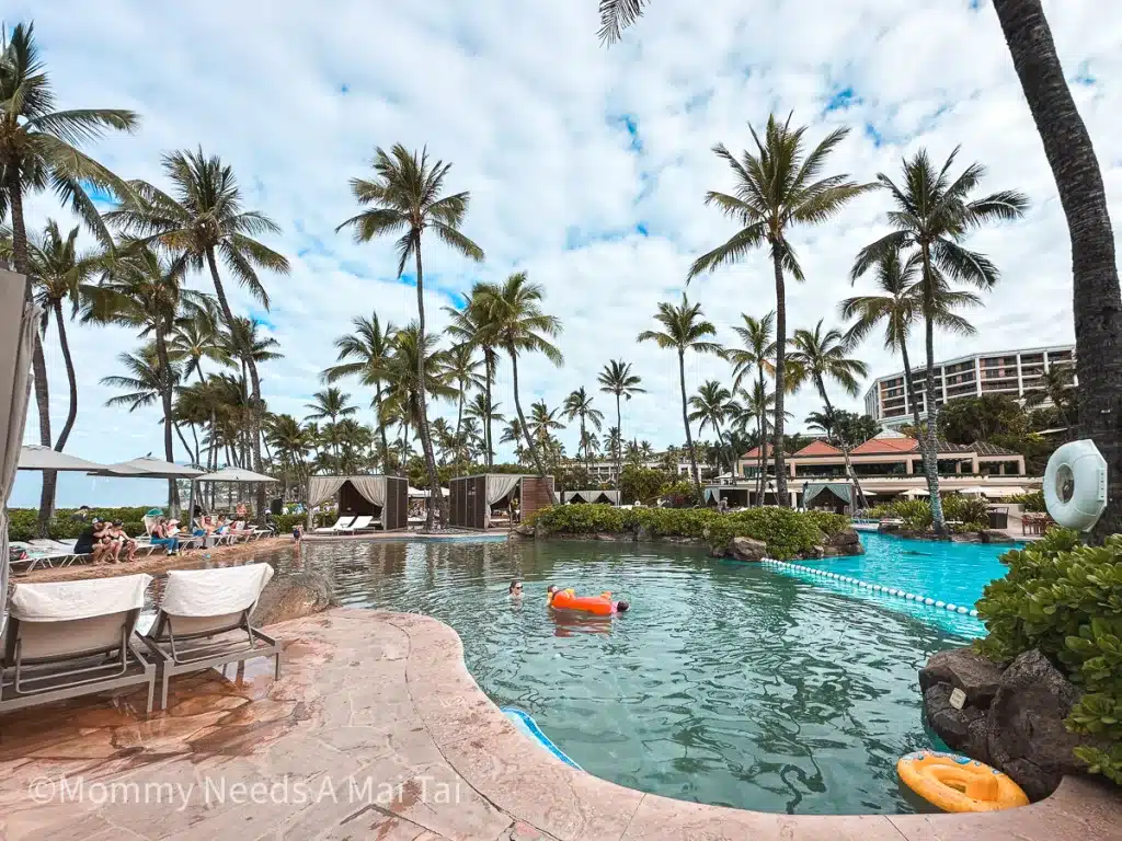 A toddler pool with sand and palm trees in the background at the Grand Wailea in Maui, Hawaii. 