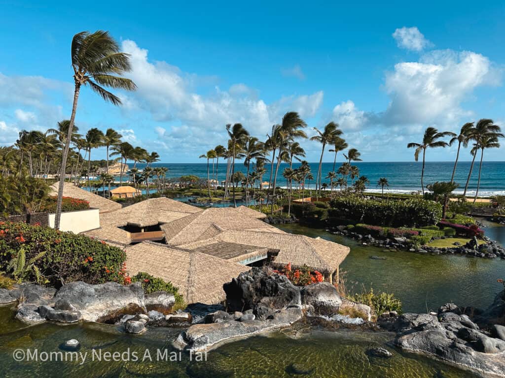A birds eye view of Grand Hyatt Kauai Resort and Spa in Hawaii with the ocean in the background.