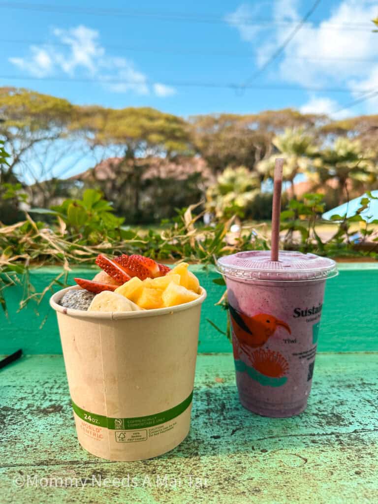 An acai bowl with strawberries, pineapple, and banana next to a smoothie at Little Fish Coffee on Kauai.
