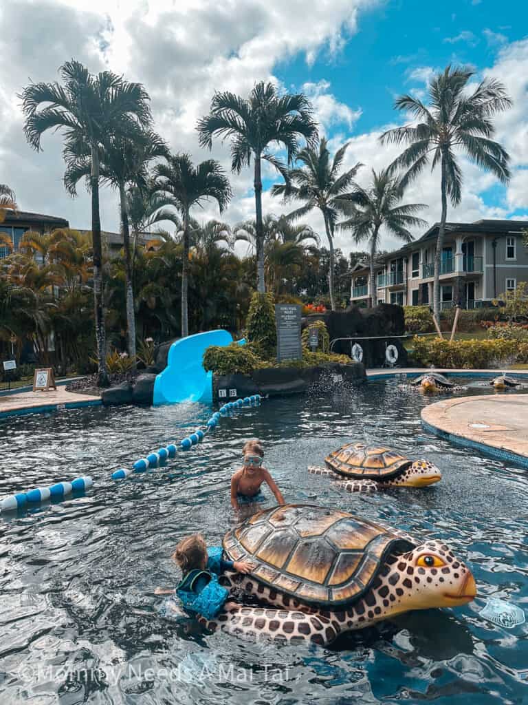 Two young kids wearing goggles and playing in the Westin Princeville Resort pool on Kauai.