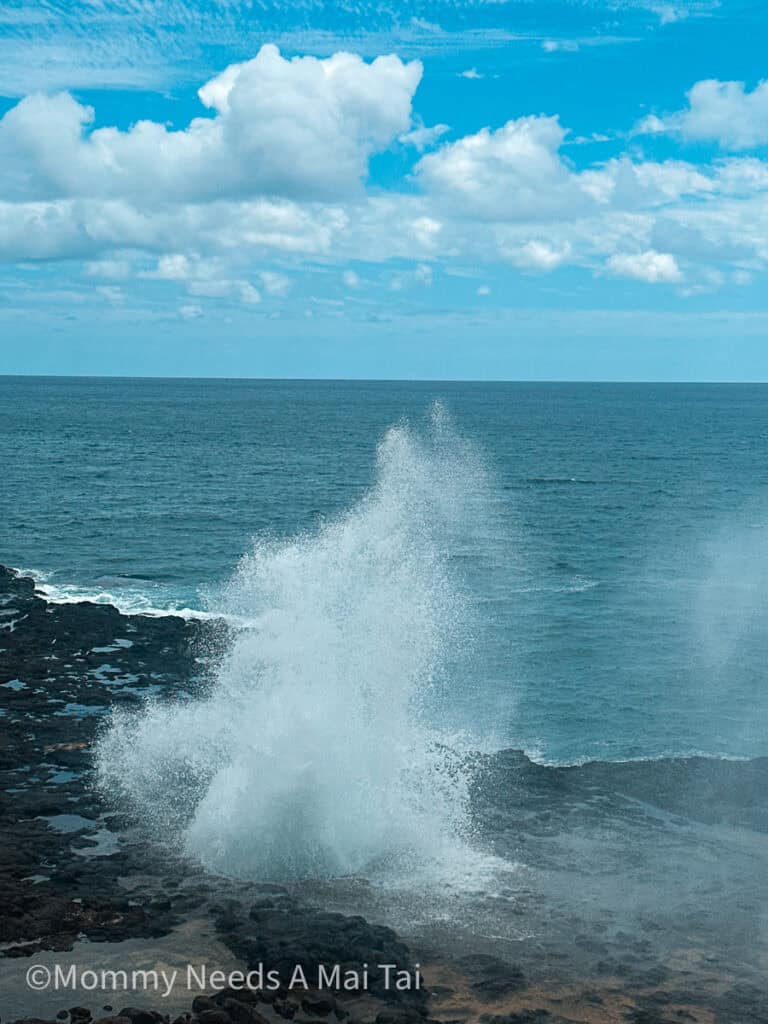 Spouting Horn Blowhole with water shooting up into the air in Koloa, Kauai.