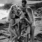 Black and white image of a family playing on the beach