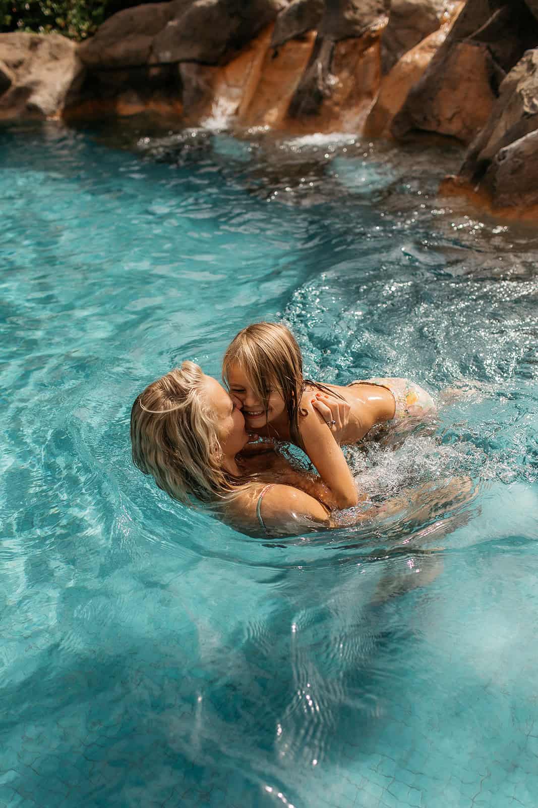 Mother playing with her child in a resort pool at a family-friendly Hawaii hotel